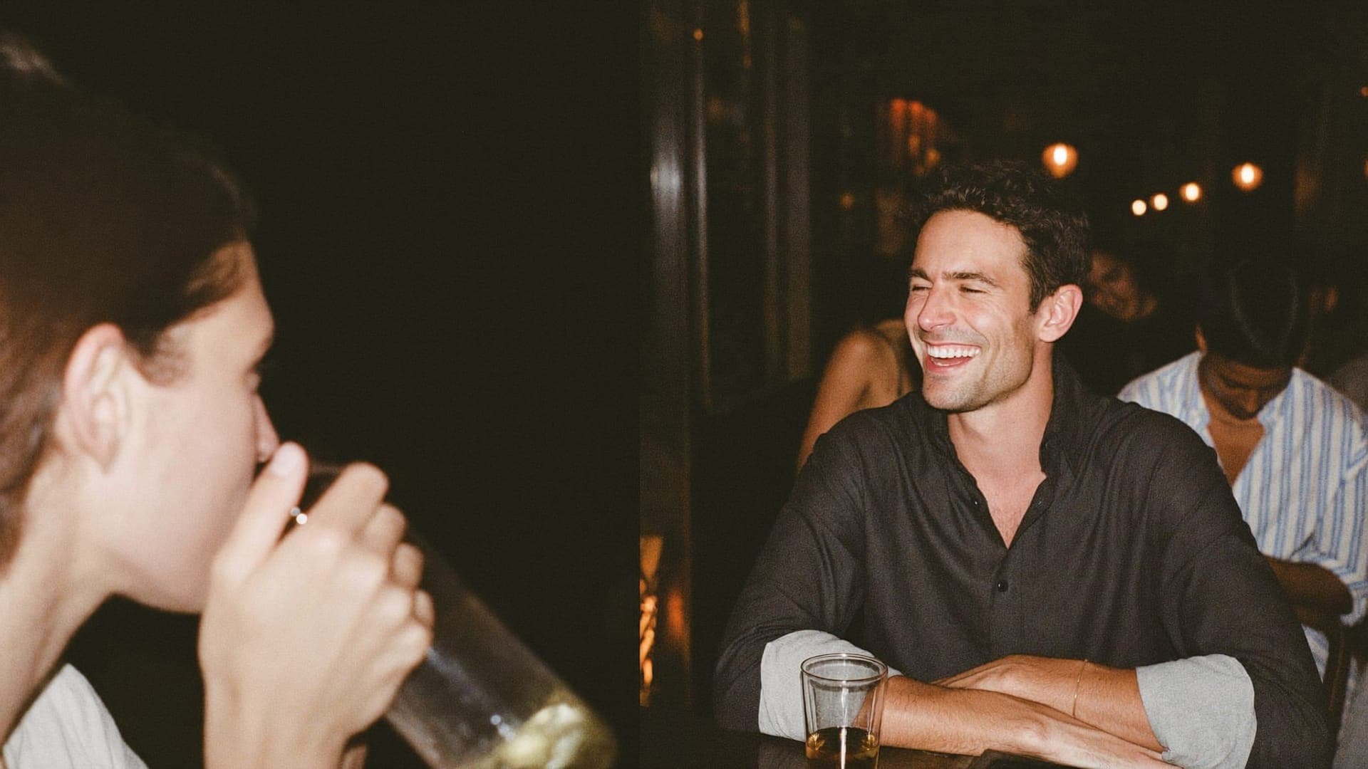A man laughing with friends at a restaurant bar